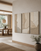 Wabi-sabi textured canvas triptych in a warm modern interior