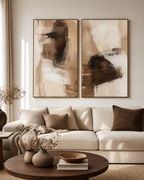 Brown and beige abstract diptych above a cream sofa